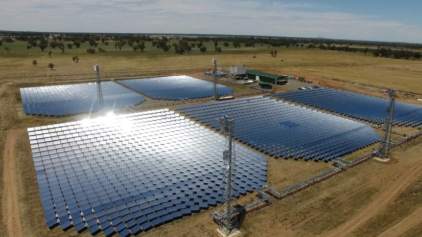 Aerial photo of five large sections of solar panels as part of a renewable energy project