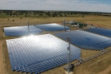 Aerial photo of five large sections of solar panels as part of a renewable energy project