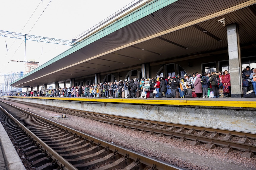People line a train platform in Kyiv, Ukraine.