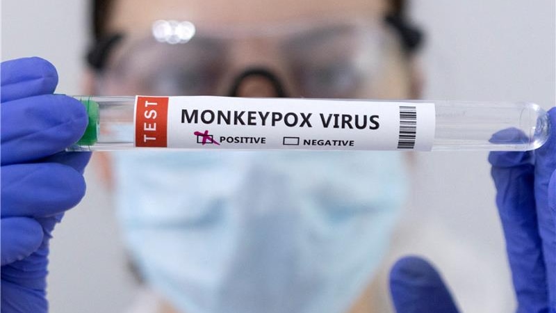 a health professional holding a vial of monkeypox dose