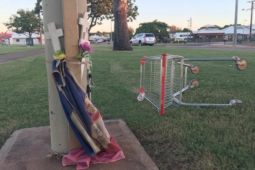 white crosses strapped to a pole.