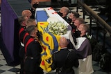 Prince Philip's coffin is carried into St George's Chapel.