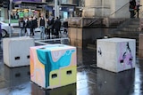 Concrete security bollards in Bourke Street mall painted by street artists.