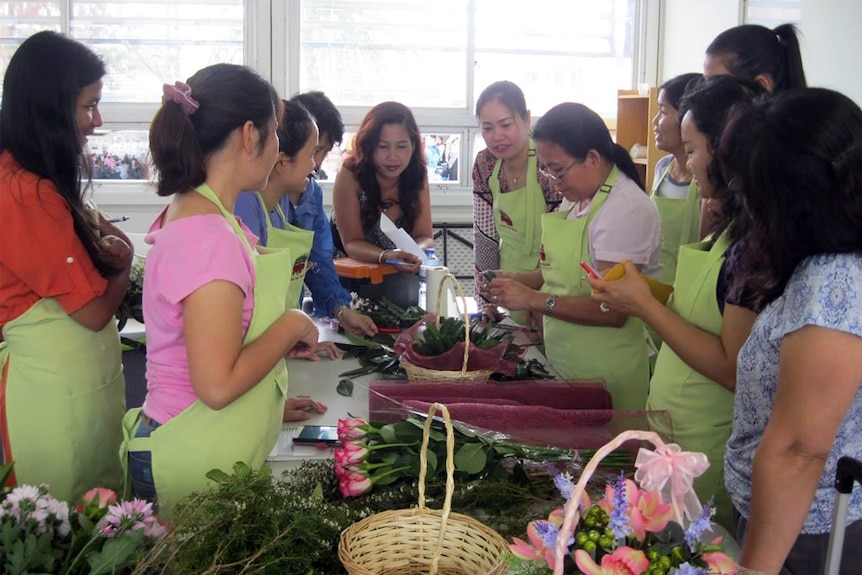 Women participate in a beginners' floristry class at Angkor Flowers in Cabramatta, in Sydney's west.