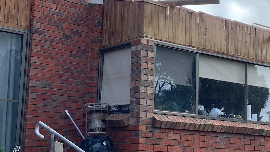 Photo of a house with significant storm damage.