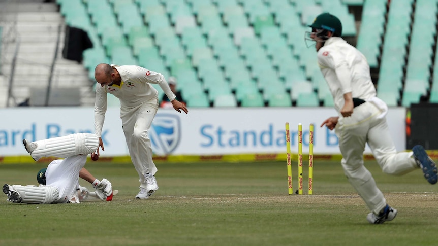 Nathan Lyon looks down at AB de Villiers after running the South Africa batsman out at Kingsmead.