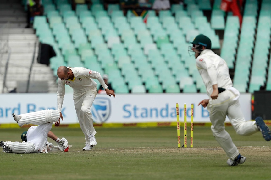 Nathan Lyon looks down at AB de Villiers after running the South Africa batsman out at Kingsmead.