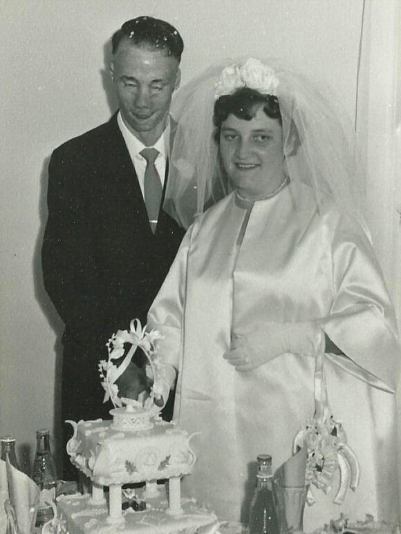 Groom and Bride cutting the cake on their wedding day