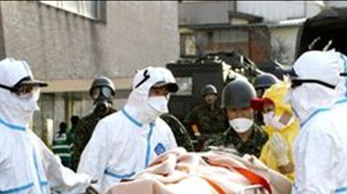 A person suspected of contamination is taken to radiation centre in Fukushima prefecture.