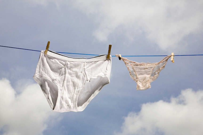 A pair of white Y-fronts hang on a clothes line next to a pair of women's briefs