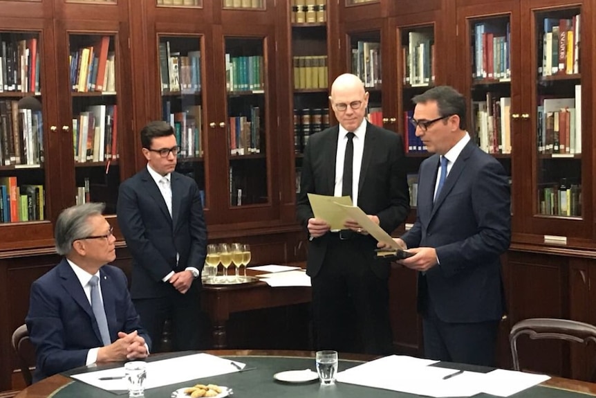 Governor Hieu Van Le watches as Steven Marshall takes the oath to become SA Premier.