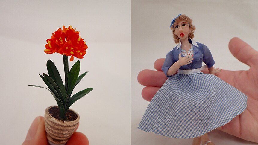 Composite of a hand holding a miniature pot plant and a doll.