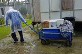 A man moves goods on a trolley around a decommissioned section of the Manus Island detention centre.