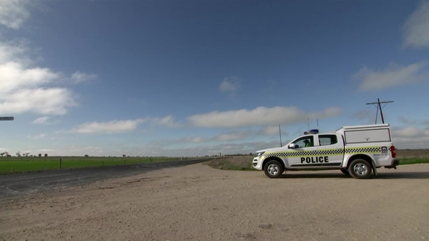 A police wagon next to a quiet road