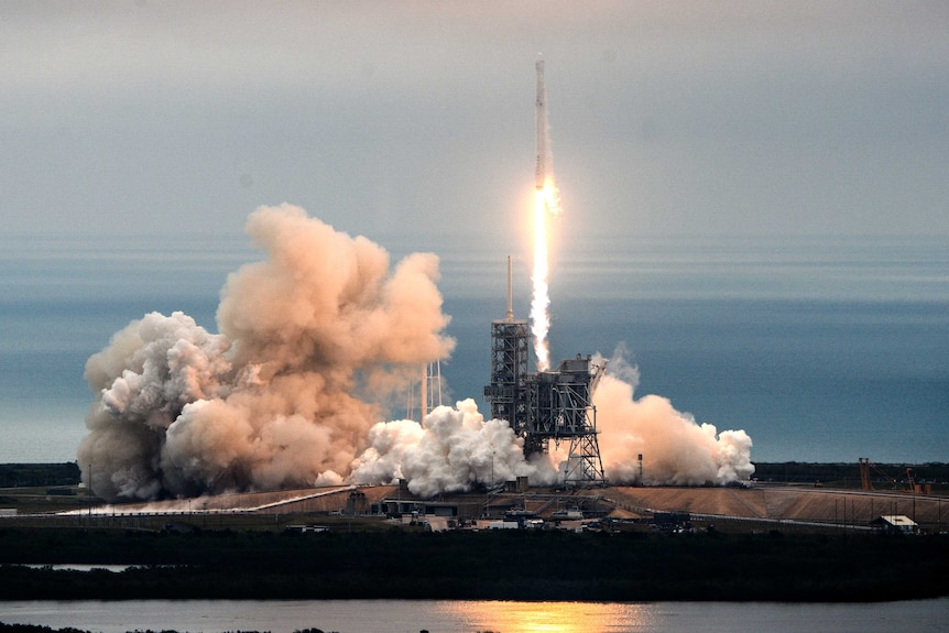 Smoke billows around moonpad as SpaceX Falcon rocket lifts off