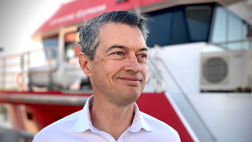 Sun Cables Australia CEO David Griffen is wearing a white shirt and smiling at the camera.