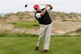 Donald Trump practices his golf swing at a course in Scotland.