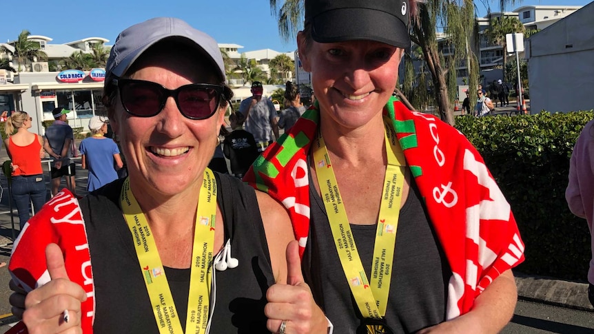 tow women with medals celebrate a win