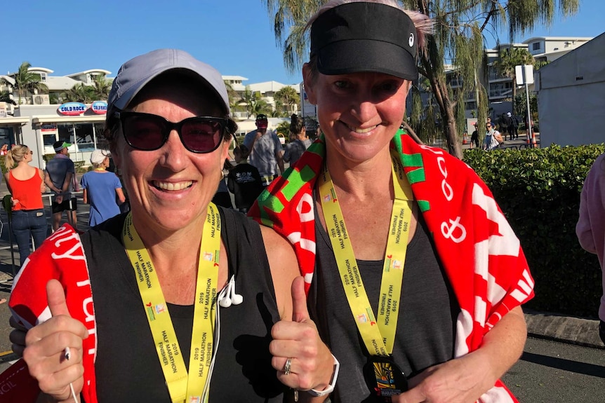 tow women with medals celebrate a win