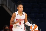 WNBA dribbles the ball down the court during a basketball match