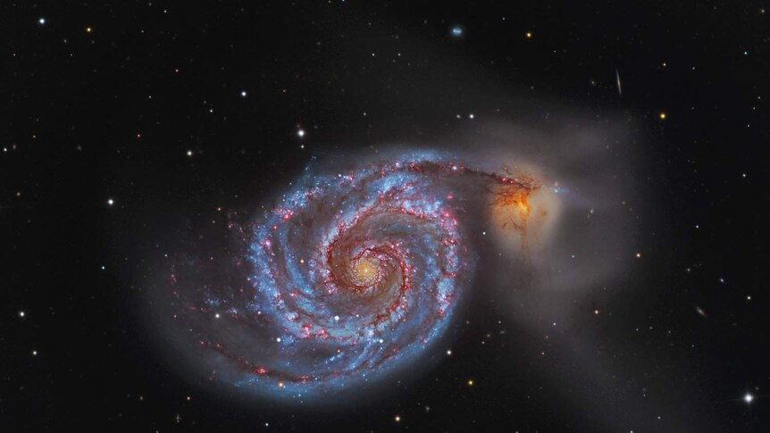 photograph of an outerspace galaxy that looks like a whirlpool