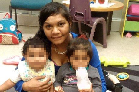 Lorraine Jane Hansen with two young children whose faces are blurred.