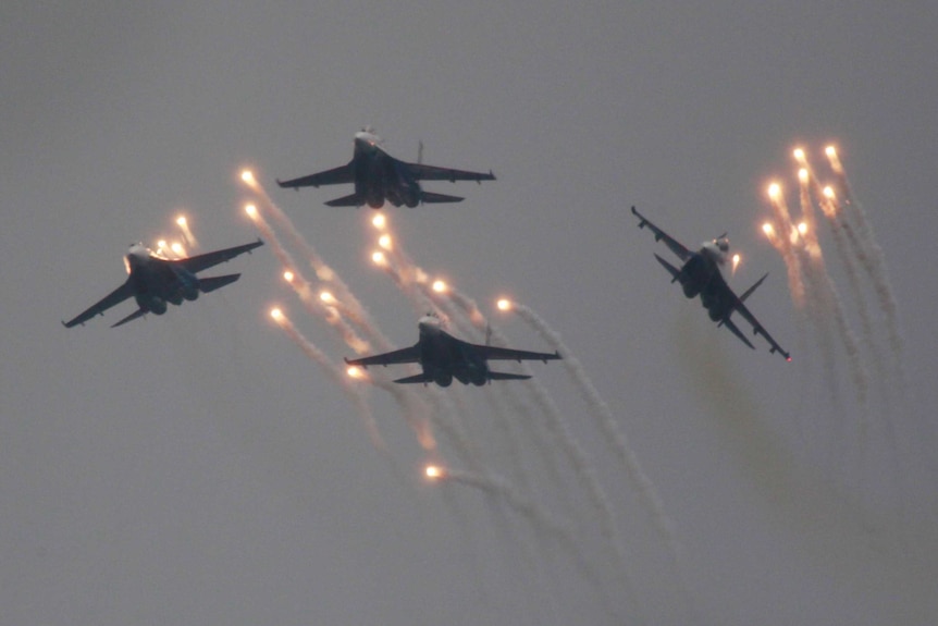 Four Russian Sukhoi Su-27 fighter jets fly in formation.