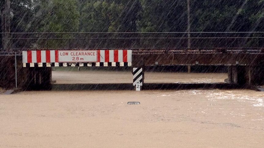 The top of a road sign sticks out of floodwaters at the Pomona Bridge.