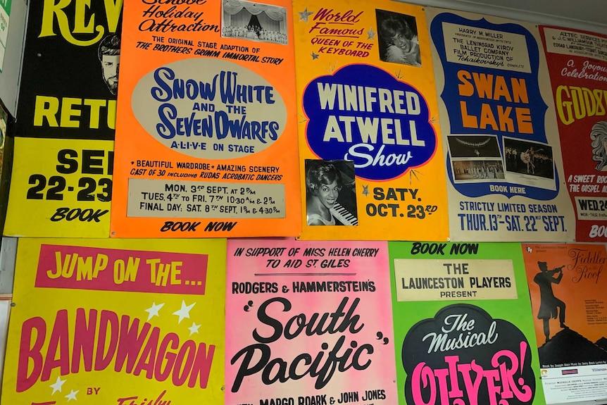 A wall covered with colourful old theatres posters from the 1970s onwards.
