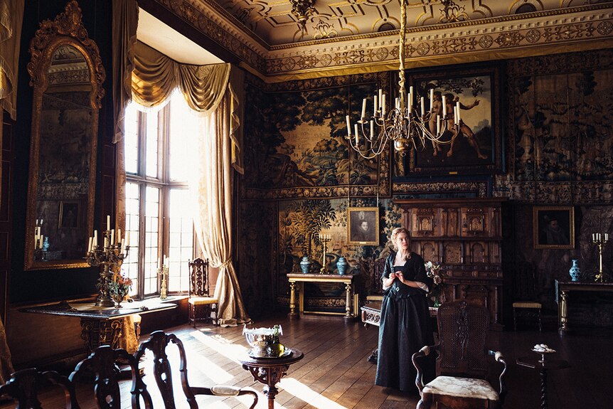Emma Stone in intricately decorated room in 2018 film The Favourite.
