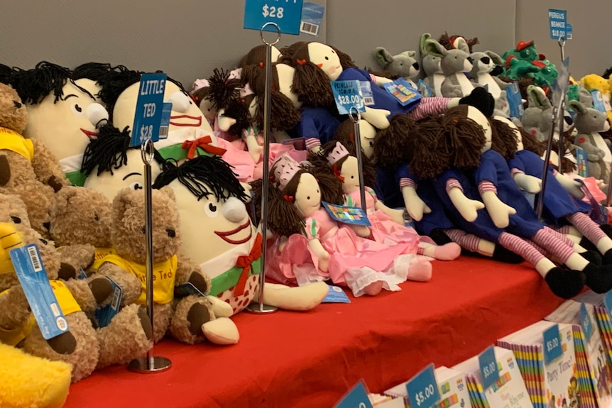 Rows of Playschool toys for sale on a table including humpty, Jemima and Little Ted