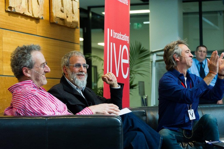 Faine, Stevens and Nankervis laugh, while chatting on a couch during a radio broadcast.