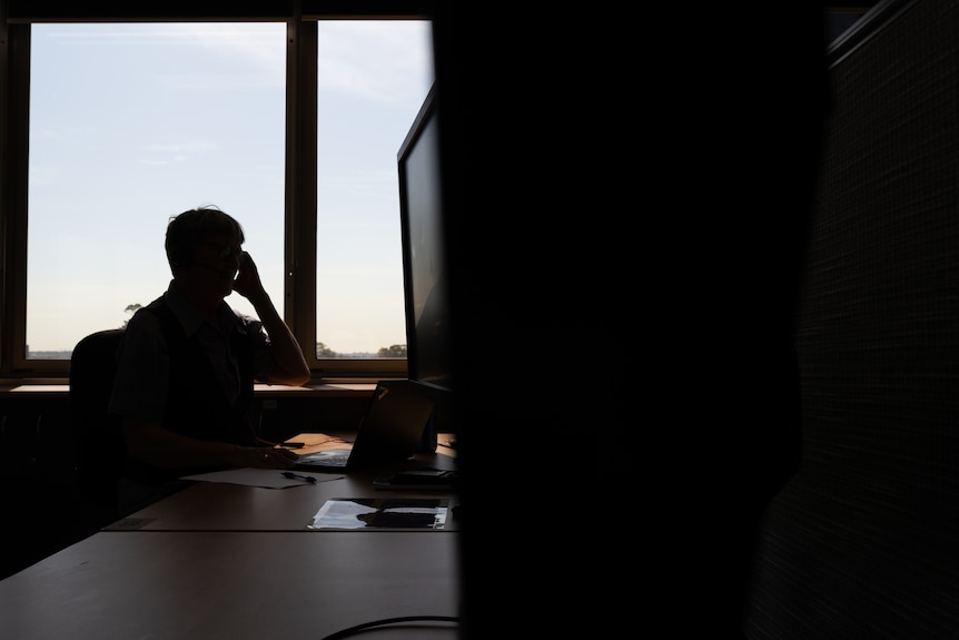 Silhouette of domestic violence call centre helpline worker