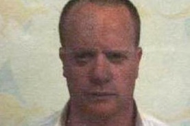 Grainy head and shoulders shot of missing Perth man Sean David Mitchell looking at the camera.