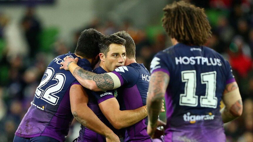 Melbourne Storm team-mates congratulate Cooper Cronk after his field goal against Wests Tigers