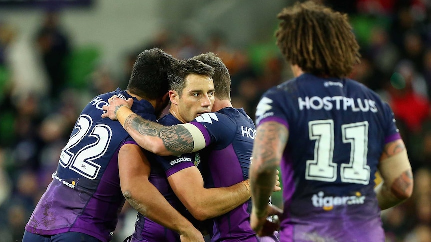 Melbourne Storm's Cooper Cronk (C) celebrates after his field goal against Wests Tigers.