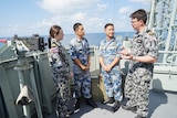 Australian sailors speak to People’s Liberation Army-Navy sailors on board HMAS Newcastle.