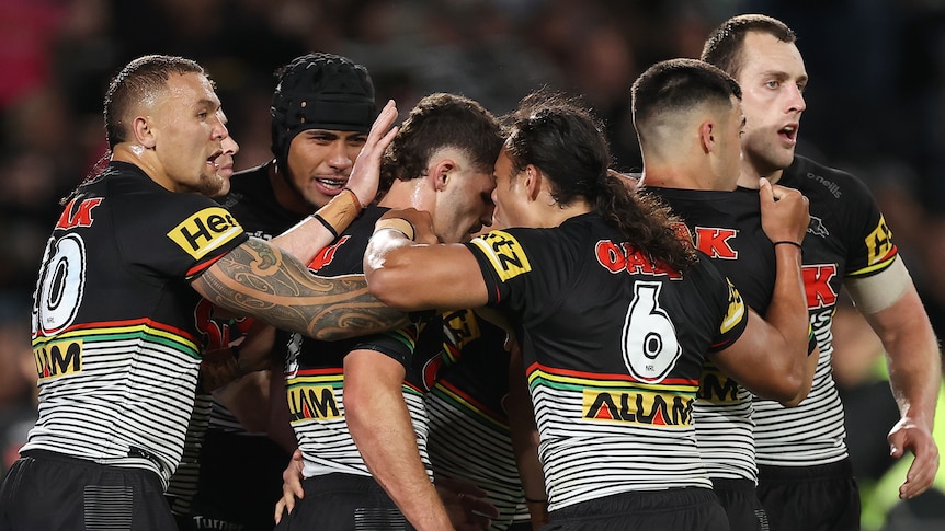 Penrith Panthers NRL players embrace as they celebrate a try against Parramatta.