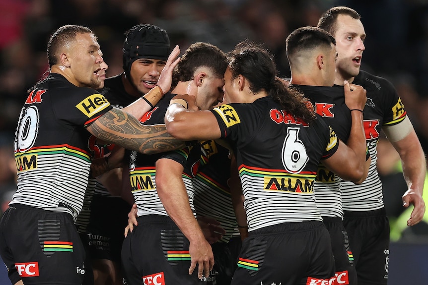 Penrith Panthers NRL players embrace as they celebrate a try against Parramatta.