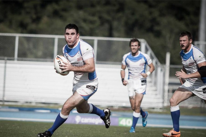 Josh Cock playing rugby league with the Jacksonville Axemen