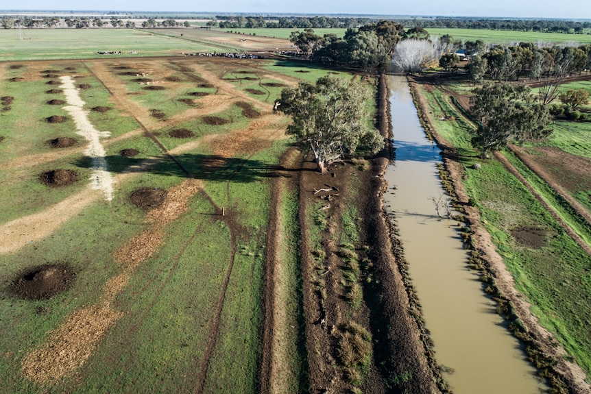 An aerial shot of a water channel on a farm.