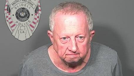 A mugshot of a 67-year-old man wearing a grey t-shirt.
