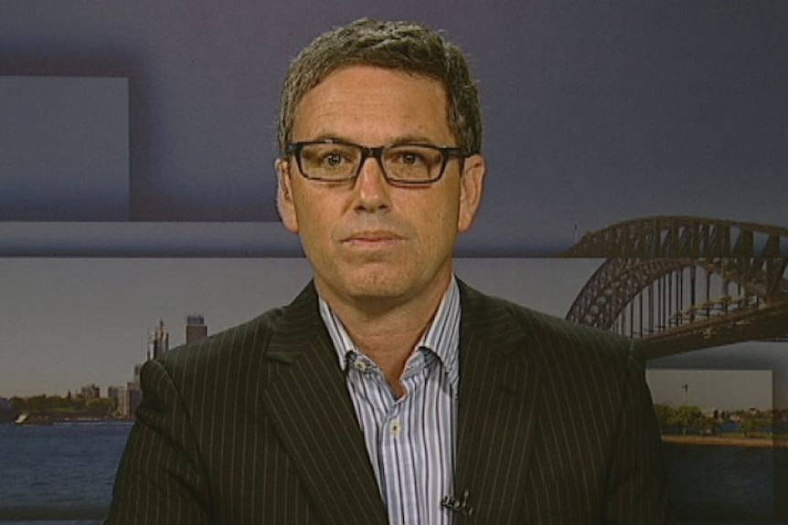 man looking serious in front of sydney background