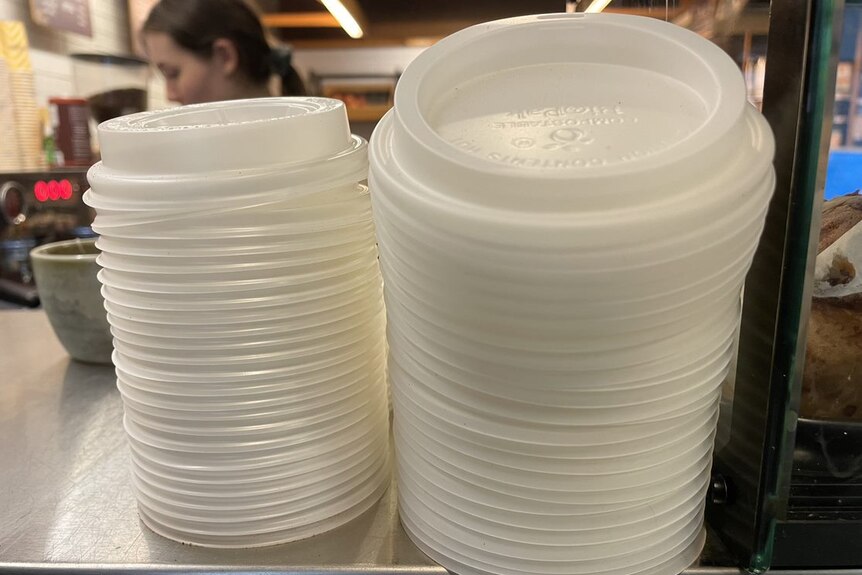 Piles of plastic takeaway coffee cup lids