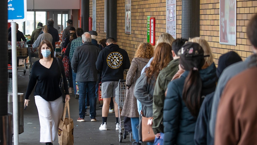 Shoppers lineup to enter a supermarket in Auckland