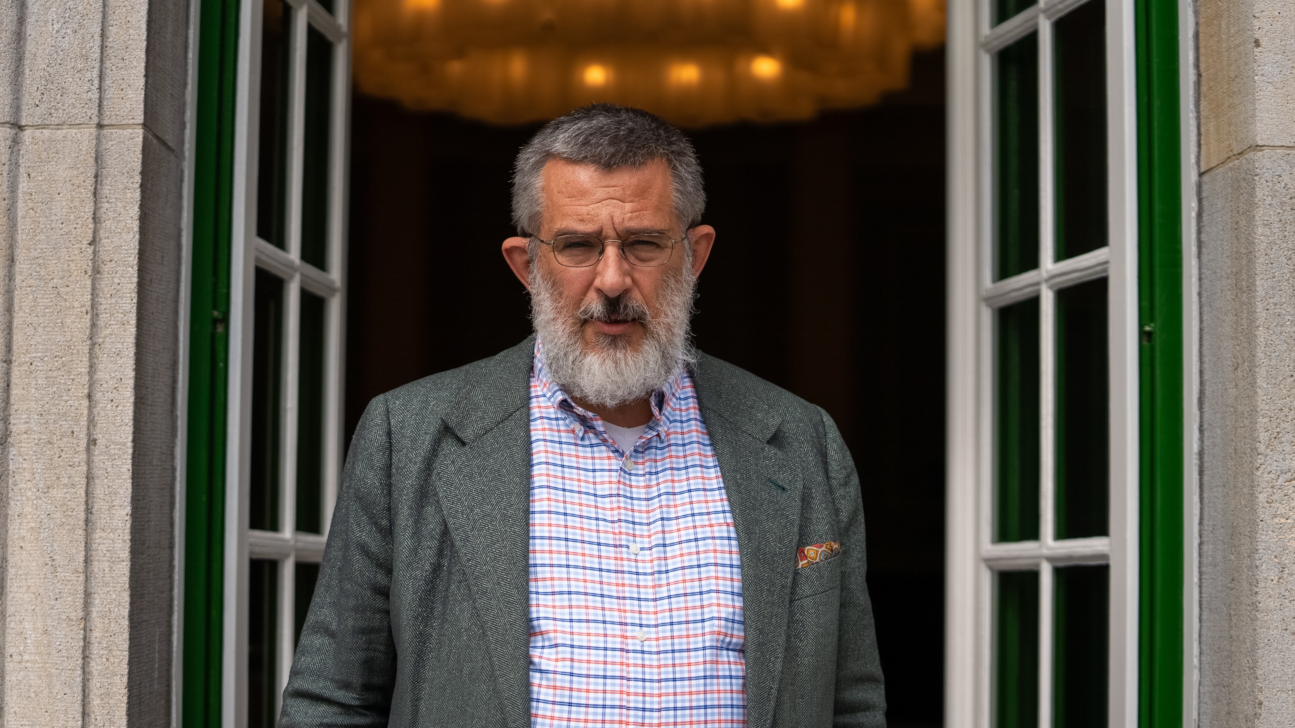 A man stands in a doorway.