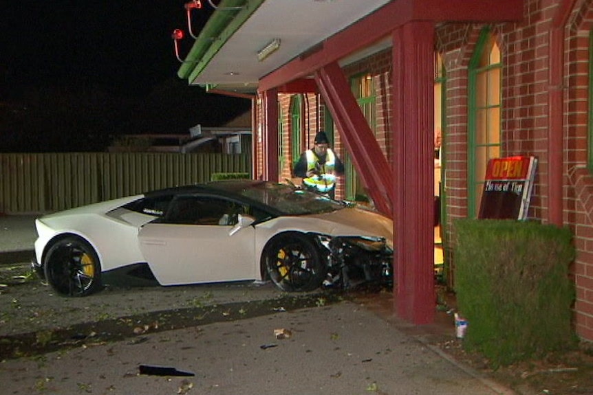 A sports car crashed into a restaurant with red columns