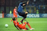 Tight contest ... Wesley Sneijder is tackled by Alou Diarra