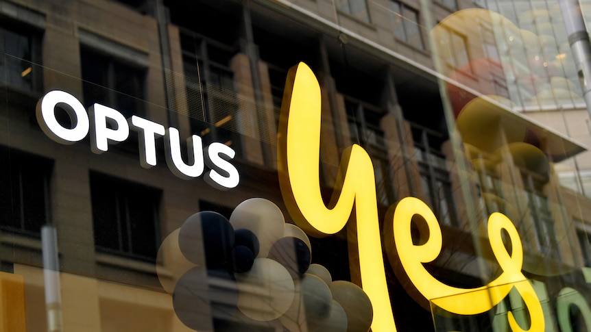 optus 'yes' sign on glass fronted office block