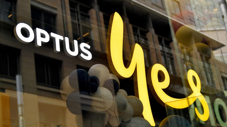 Signage on a store window reading "OPTUS YES"